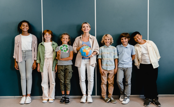 schoolchildren-classmates-kids-pupils-students-standing-with-teacher-holding-globe-and-recycling-sign-at-geography-school-lesson-class-eco-activists-environment-protection-