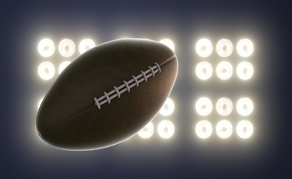 super-bowl-football-spinning-on-floodlight-background