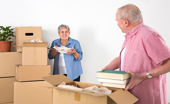 senior-adult-couple-relocation-and-unpacking-books