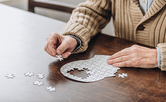 cropped-view-of-senior-man-playing-with-puzzles