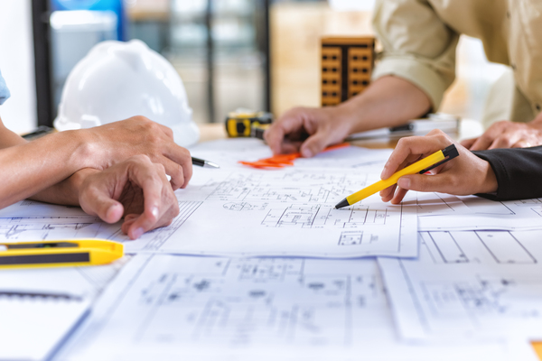 image-of-team-engineer-checks-construction-blueprints-on-new-project-with-engineering-tools-at-desk-in-office-
