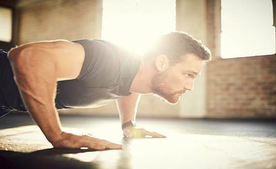 side-view-of-determined-man-doing-push-ups-in-gym-gym