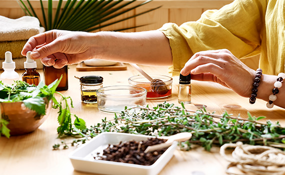 A woman checking various herbs and spices in a kitchen. 
