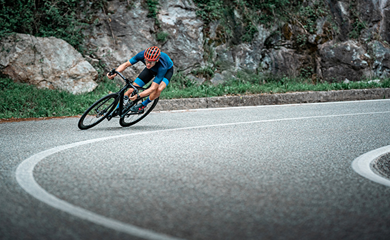 bicycle-racing-cyclist-on-asphalt-road-curve