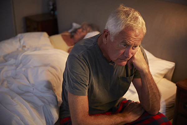 worried-senior-man-in-bed-at-night-suffering-with-insomnia