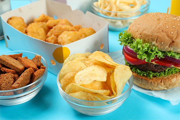 AUP de origem vegetal numa tabela azul: nuggets, hambúrgueres e batatas fritas.