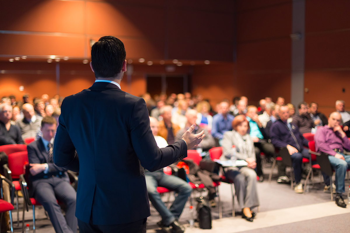 a-man-speaking-at-a-business-conference