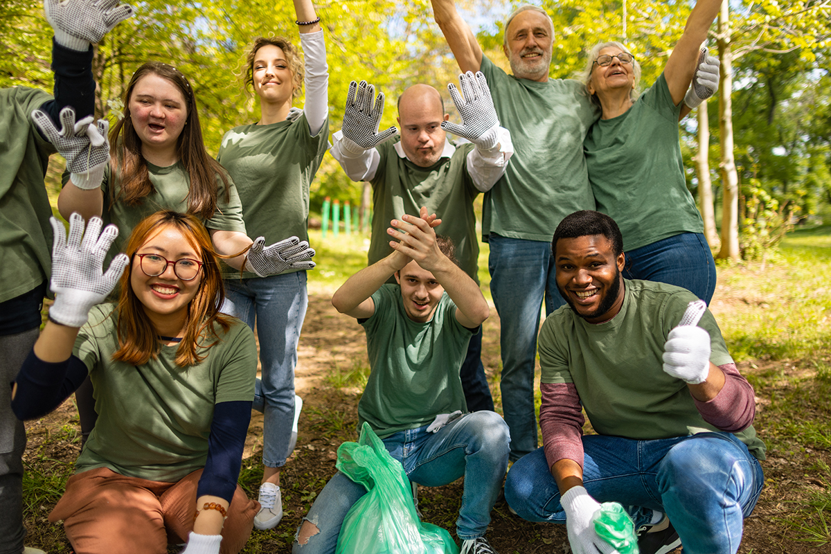 volunteers-waving-to-camera-after-collecting-garbage-in-a-forest