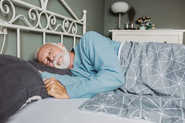 Um adulto mais velho dorme tranquilamente para preservar a função cognitiva.