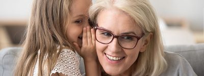 grandchild-telling-secret-to-grandma